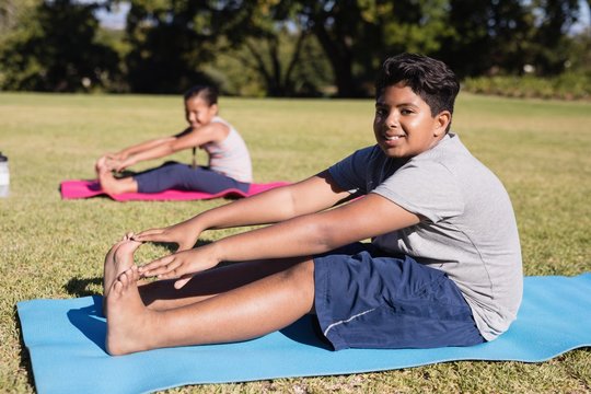 Portrait Of Boy Touching Toes During Yoga Glass