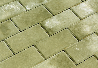 Yellow color cobblestone pavement texture.