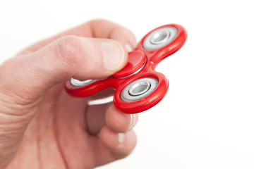 Male hand holding popular fidget spinner toy