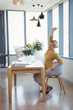 Executive Stretching Her Hands While Working At Desk