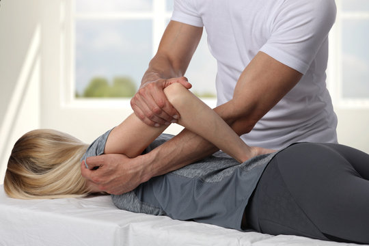 Woman having chiropractic back adjustment. Osteopathy, Acupressure, Alternative medicine, pain relief concept. Physiotherapy, sport injury rehabilitation