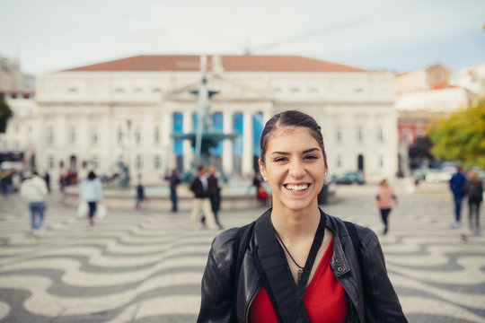 Enjoying Europe capital travel.Young traveler woman admiring beautiful Rossio square in Lisbon,Portugal.Energetic,dynamic day in cobblestoned Lisbon center streets.Travel blogger experiencing amazing