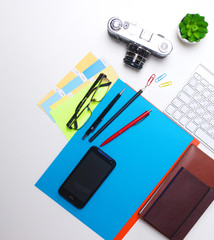 Computer keyboard, mouse and camera lie on table