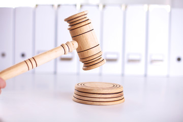 A wooden judge gavel and soundboard isolated on white background in perspective