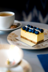 Cake with blueberries on a vintage plate.