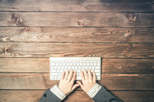 Top View Of Businesswoman Sitting At Table And Working On Keyboa