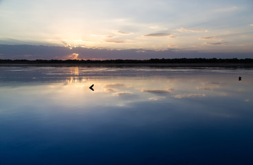 Fototapeta premium sunset on the lake as a backdrop