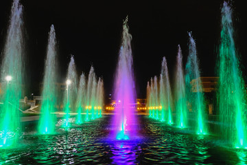 colored water fountain at night
