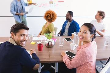 Portrait of colleagues with businessman explaining 