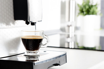 Home professional coffee machine with espresso cup.