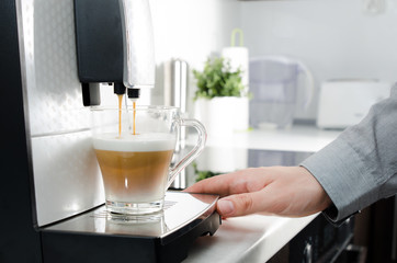 Home professional coffee machine with cappuccino cup.