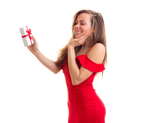 Young woman in red dress holding present