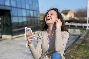 Teenage girl listening music from a smart phone
