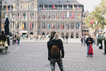 Woman standing at Jan Van Eyck Square in Bruges, Belgium