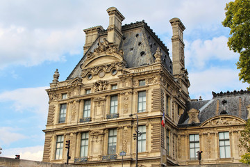 Fototapeta na wymiar View on Louvre museum building, blue sky with white clouds, paris city, france