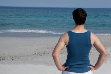Fototapeta na wymiar Man looking at sea from beach
