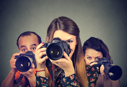 Group Of Photographers With Professional Cameras