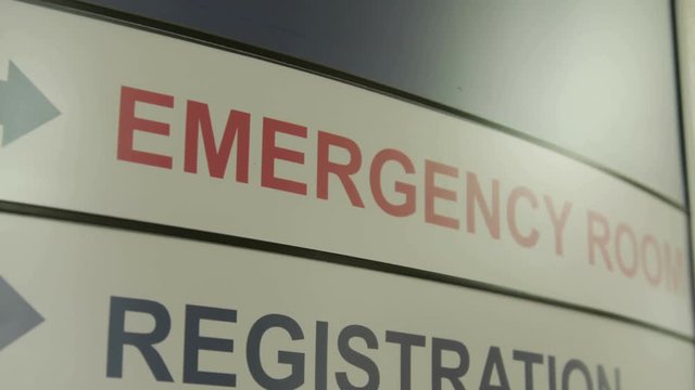 Sign for a hospital emergency room and registration desk. Shot in 4K UHD.