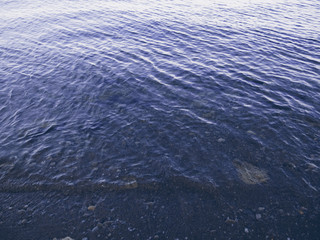 Rippled seawater in low tide photo. Still sea surface with ripples on water.