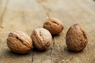 walnuts on a wooden board, closed nutshell