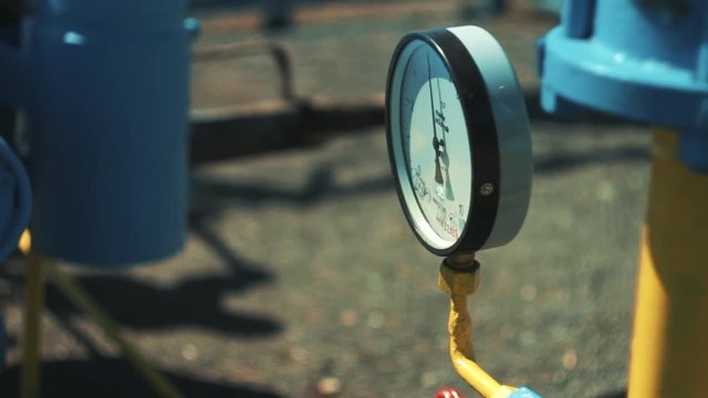 Close-up pressure gauge with shut-off valve. Gas storage and supply station. Pipelines for gas transportation. Oil and gas industry. Money business.