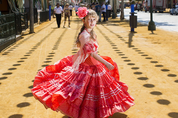 women in traditional flamenco dresses dance during the Feria de Abril on April Spain - obrazy, fototapety, plakaty