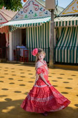 Fototapeta premium Little girls in flamenco style dress at the Sevilla, Spain. Seville's April Fair on April