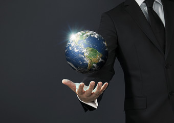 Businessman magical touch concept -  world