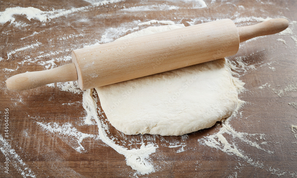 Canvas Prints Raw dough and rolling pin on wooden table