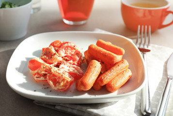 Plate with fried carrot and tomatoes on table served for lunch, closeup © Africa Studio