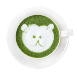 Hot green tea matcha latte cup with cute polar bear face milk foam latte art on top isolated on white background, clipping path included.