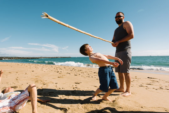 Father playing with son on beach