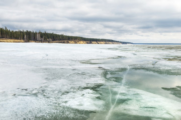 The coast of the Ob river with melting ice
