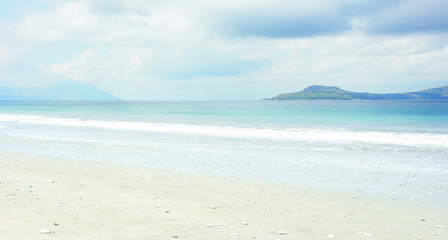 Fototapeta na wymiar Empty white sand beach and clear blue ocean waves at Bajawa Ruting Flores in the morning.