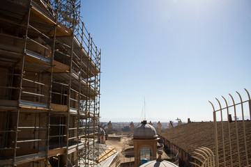remontowany dach zabytkowej bazyliki z lukarną na tle błękitnego nieba © Magdalena