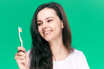 happy woman on a green background, toothbrush