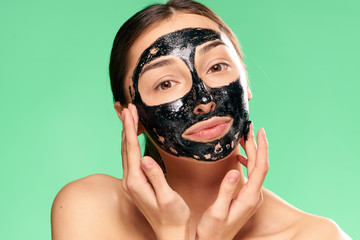 woman in a black mask on a green background