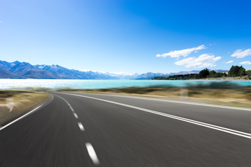 empty road with blue sea in blue sky