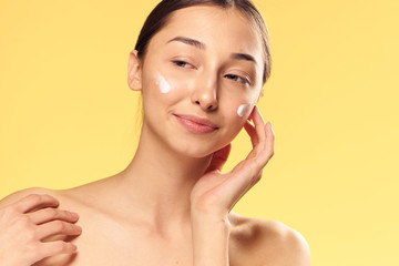 spa, cream on woman face, yellow background