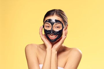 young woman in black mask for face, charming smile