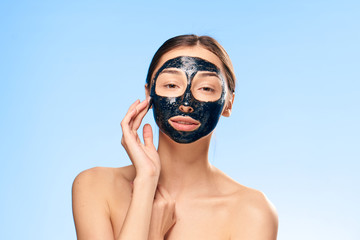 Fototapeta premium beautiful woman with a black mask on her face
