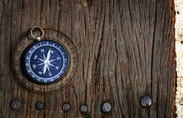 compass on old wood background, flat top view, find the right path concept
