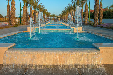 Obraz na płótnie Canvas Ashkelon seaside park fountains colored evening light