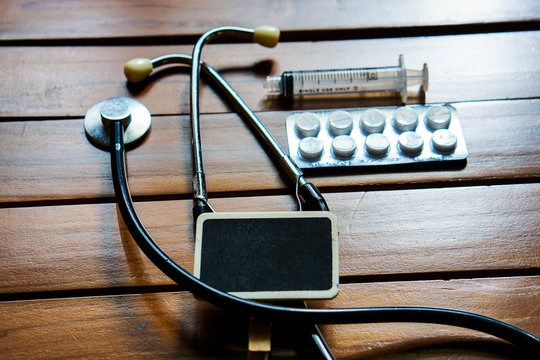 Stethoscope, pills and Syringes empty on color background. medicine concept