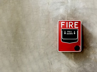 Fire alarm switch on concrete background and copy space