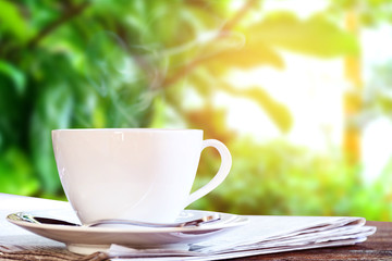 coffee cup clock and news paper on old wooden table