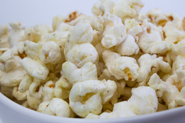 Popcorn in white bowl closeup image white background
