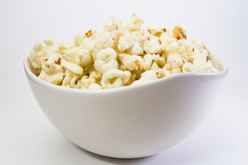 Popcorn in white bowl closeup image white background