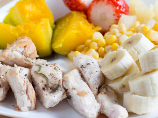 Grilled chicken breasts with pumpkin, corn, banana and strawberry