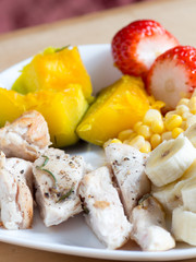 Grilled chicken breasts with pumpkin, corn, banana and strawberry